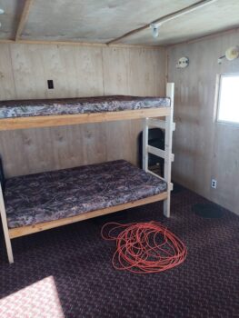 Bunk Bed With A Red Rope On The Floor